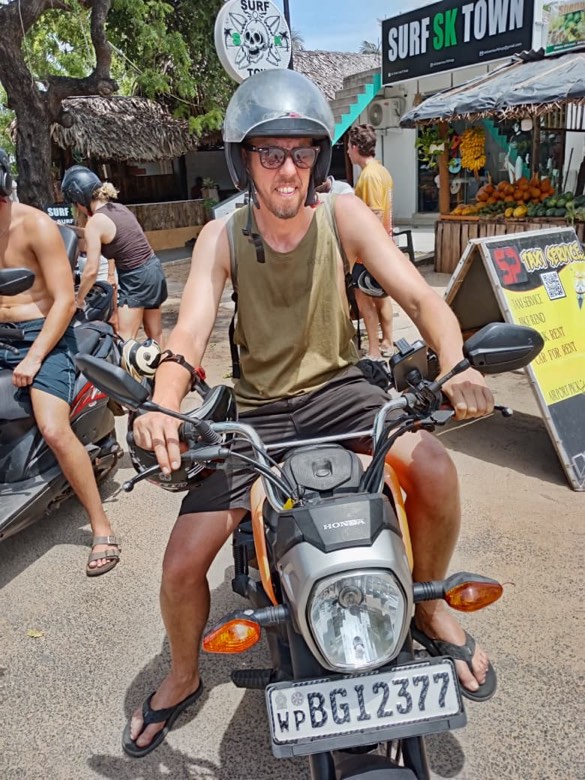 A smiling customer on an SP rental scooter in Arugam Bay
