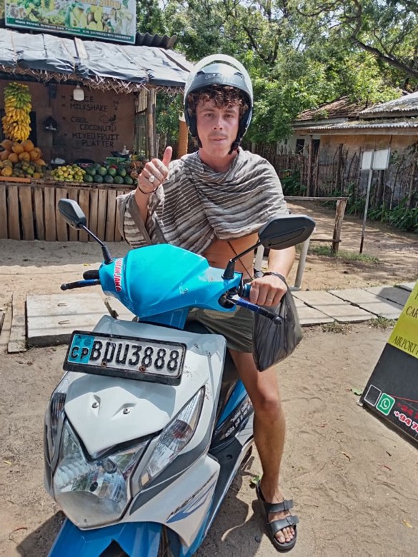 A traveller with a loaded SP rental scooter, ready to set off