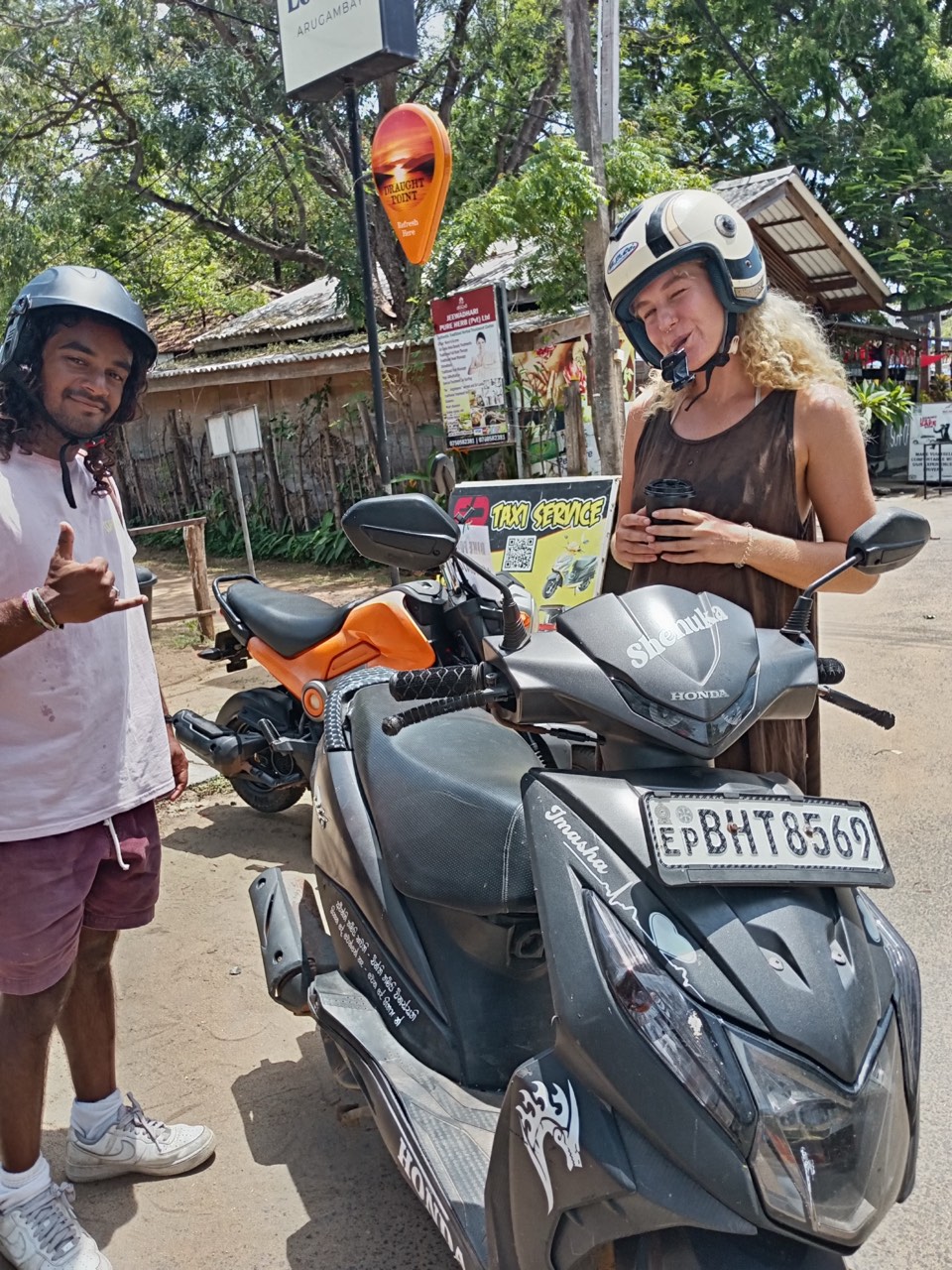 Two friends with their SP rental scooters in Arugam Bay