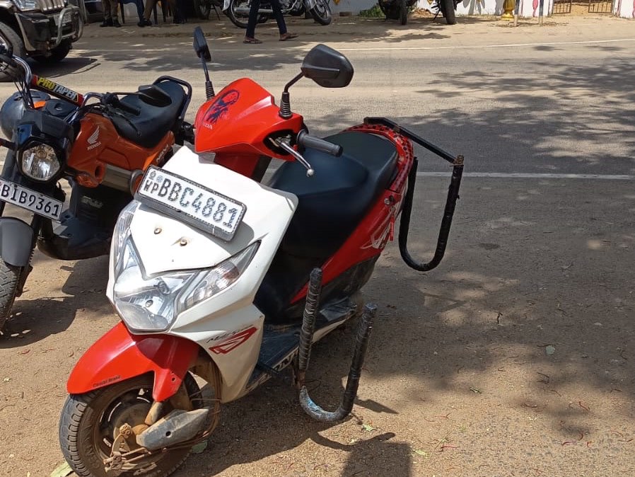 A scooter with a surfboard side-carrier rack, SP Scooter & Taxi Arugam Bay