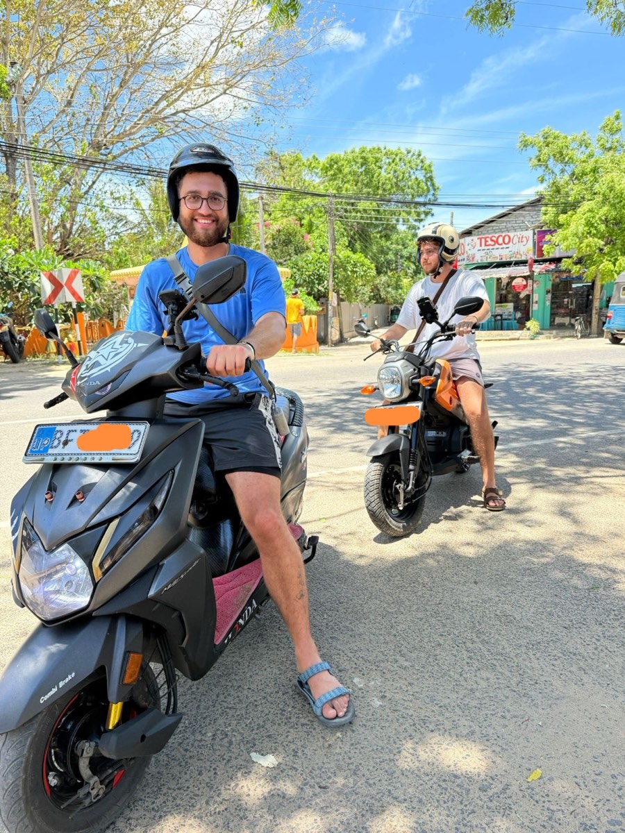 A happy SP Scooter & Taxi customer riding a rental scooter in Arugam Bay